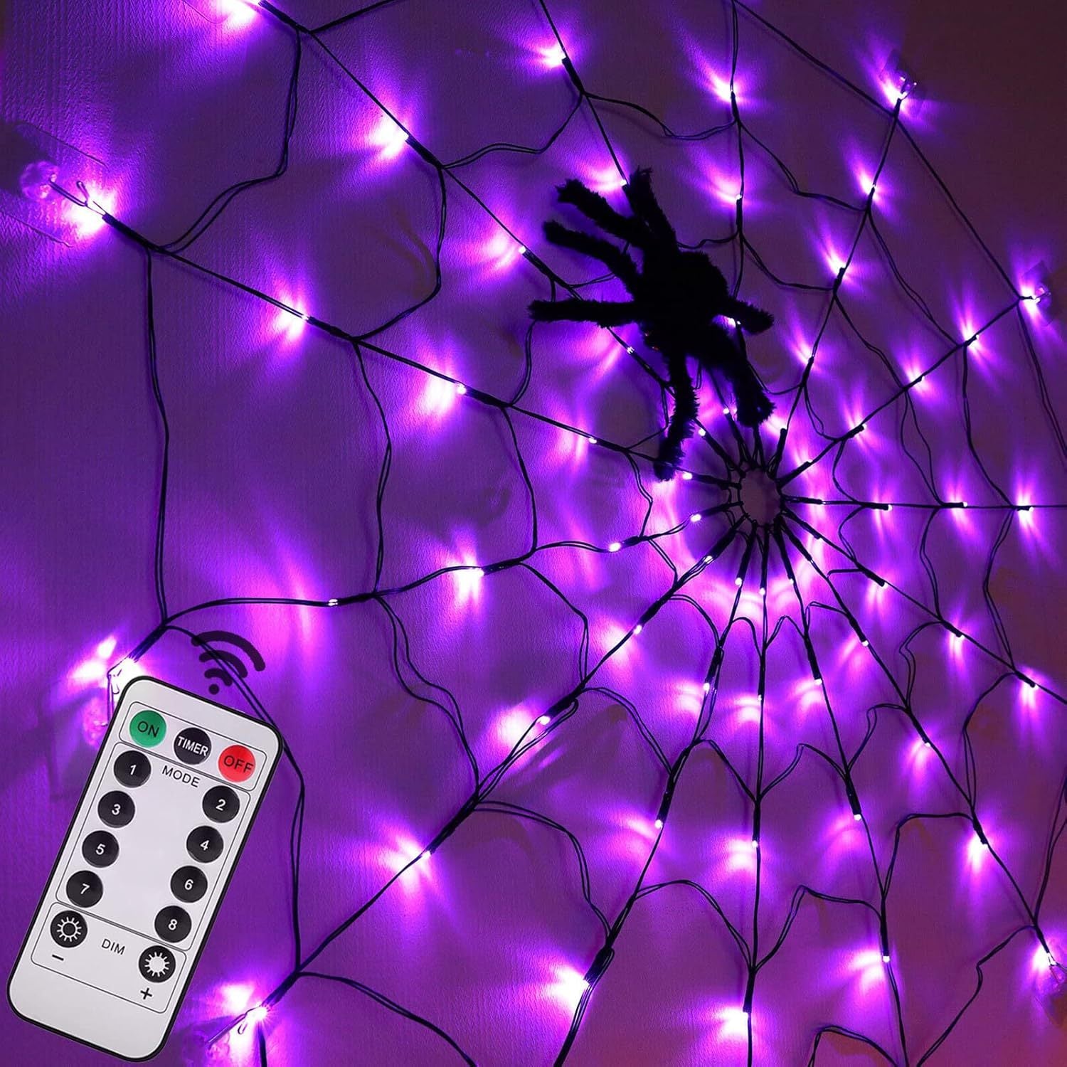 Purple glowing spider web net light with a black spider prop and a remote control