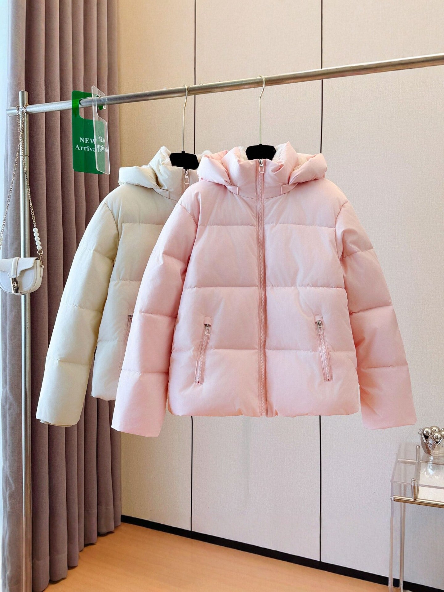 Fleece lined hooded puffer jacket with a rounded quilted silhouette and full zip