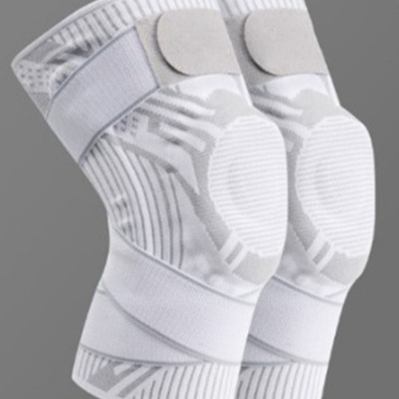 White knit sports knee brace with padded kneecap panel and support strap