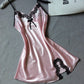 Pink satin slip nightdress with black lace at the neckline and a black lace motif at the hem