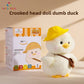 Cream duck plush in a yellow hat beside its printed gift box on a shelf