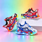 Red and blue sports car kids sneakers with rainbow LED sole lights on a white display block