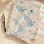 Monthly planner notebook shown open with a monthly grid and lined pages