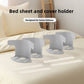 Set of four gray plastic bed sheet holders laid out together