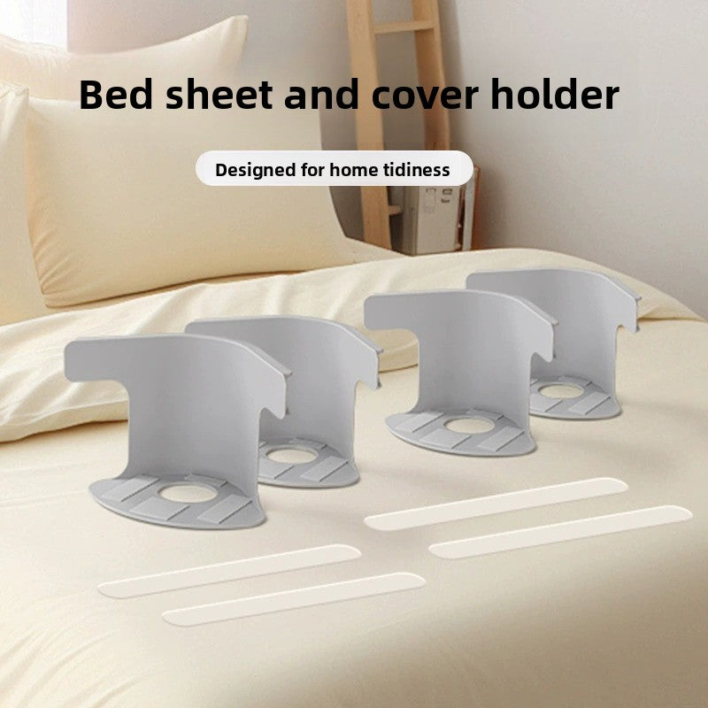Set of four gray plastic bed sheet holders laid out together