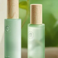 Water lotion serum and cream arranged top down on a flat surface