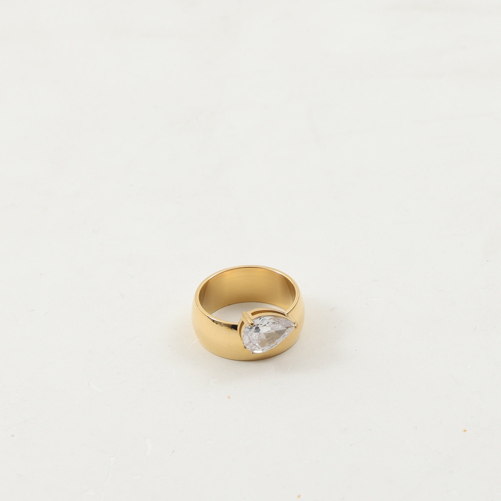 Close-up of the faceted zircon and polished gold plating on the ring band