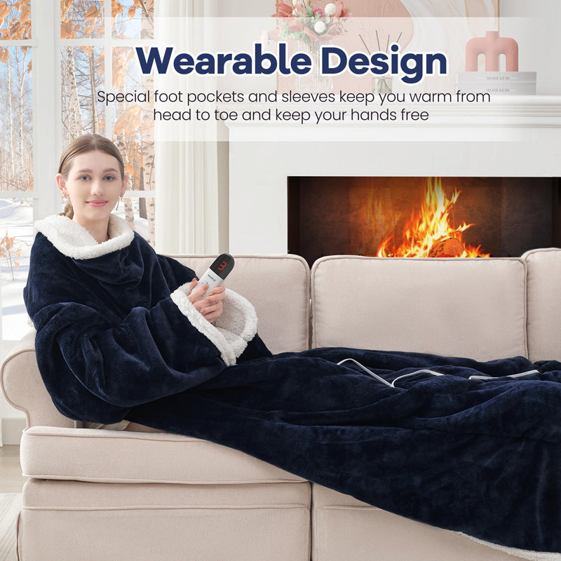 Woman on a sofa wearing a navy flannel blanket with sleeves and sherpa cuffs, holding the controller