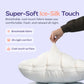 Hand pinching the smooth cool touch cover of a cream puff grid bed pillow