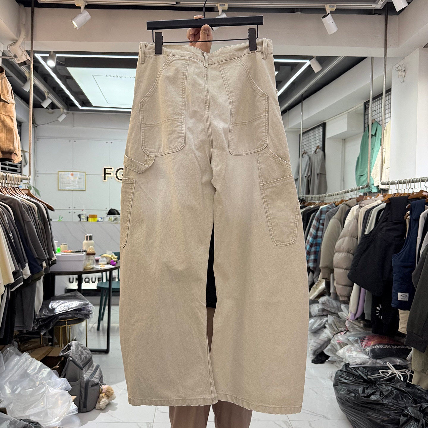 Cream carpenter pants back view showing patch pockets and wide barrel leg