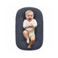 Padded baby lounger nest on an off white background showing the oval shape
