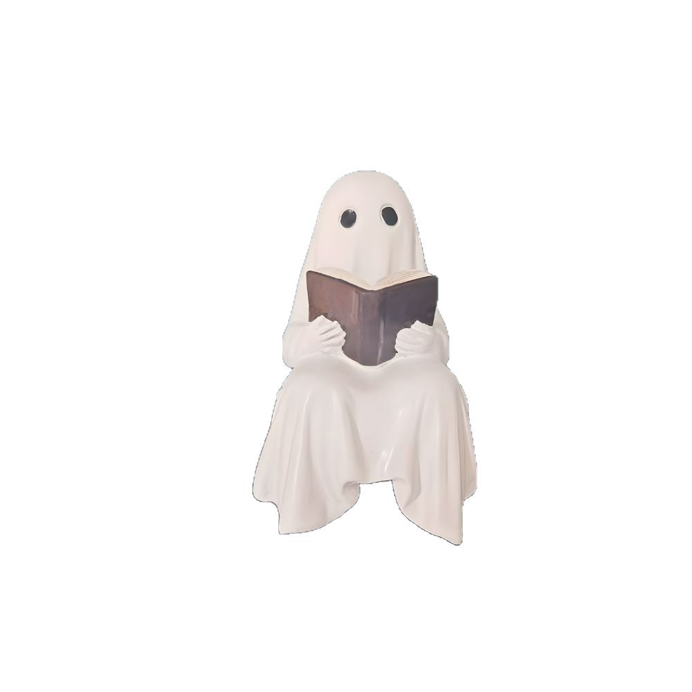 Reading ghost resin statue with a brown book on a plain white background