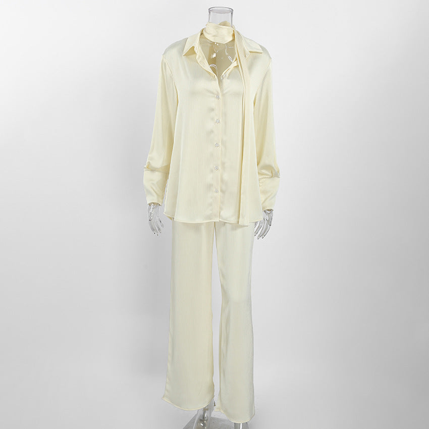 Flat lay of the buttercream loose shirt and wide leg trousers set shown on a mannequin form