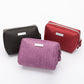 Large capacity toiletry bag standing open with bottles and tubes held upright inside