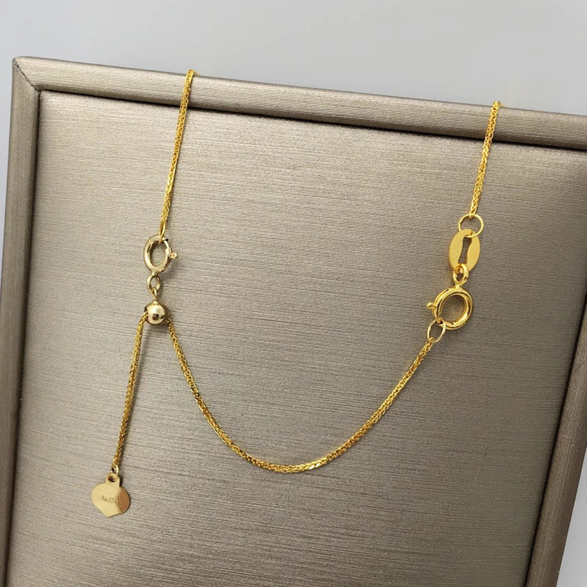 18K gold necklace extension chain shown from the side angle
