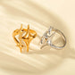 Gold and silver adjustable star rings on cream cloth with open bands visible