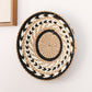 Pointed sun shaped straw wall ornament hand-coiled from natural grass fiber