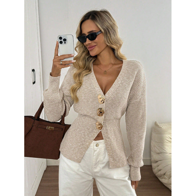 Front view of an apricot knit cardigan showing the deep V neck and three gold tone buttons