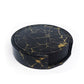 Black and gold marble PU leather round coasters stacked in a holder