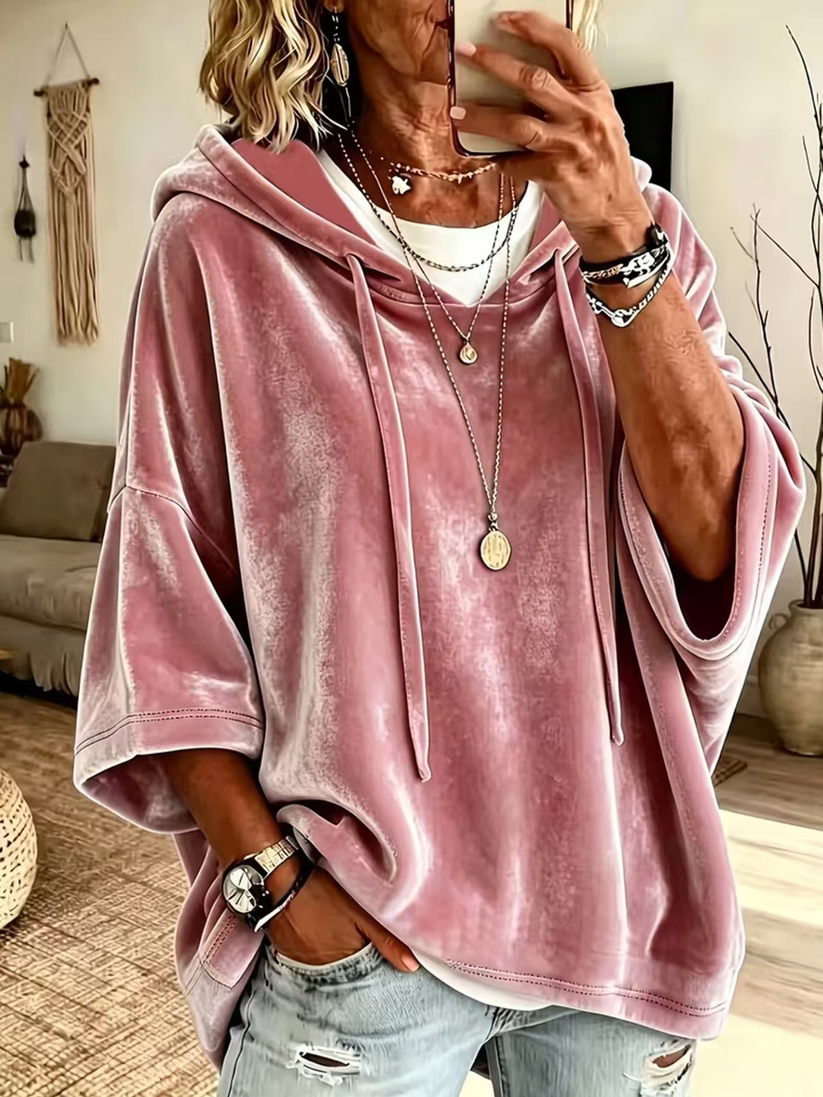 Drawstring hood and roomy body of a loose womens hooded pullover top
