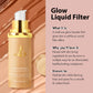 Gold toned foundation serum pump bottle photographed close up over a swirl of peach coloured liquid base