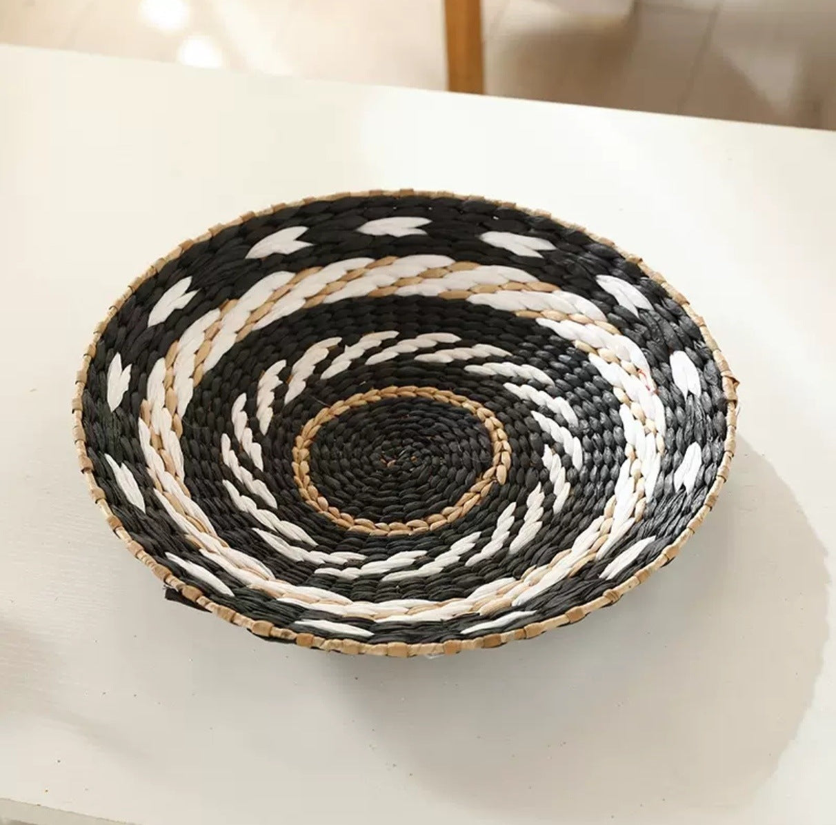 Set of woven straw wall discs in mixed sizes and Nordic black and white tones