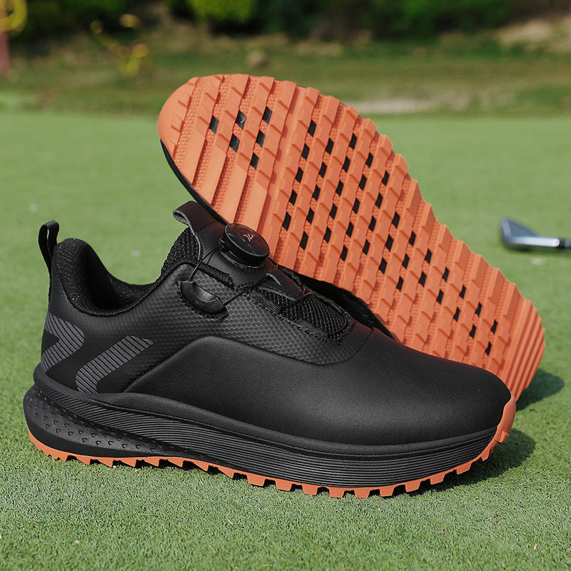 Black low top golf shoe with a twist dial closure and an amber nubbed spikeless outsole