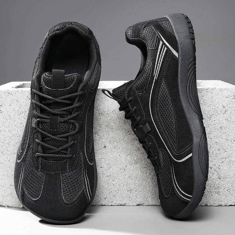 Black mesh lace-up sneakers with a flat black rubber sole on a concrete block, size 40 option photo