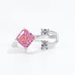 Radiant pink stone facing two clear oval accents across an open band stamped S925 near the opening