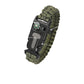 Green paracord bracelet with moulded buckle carrying a compass, a whistle and a striker blade