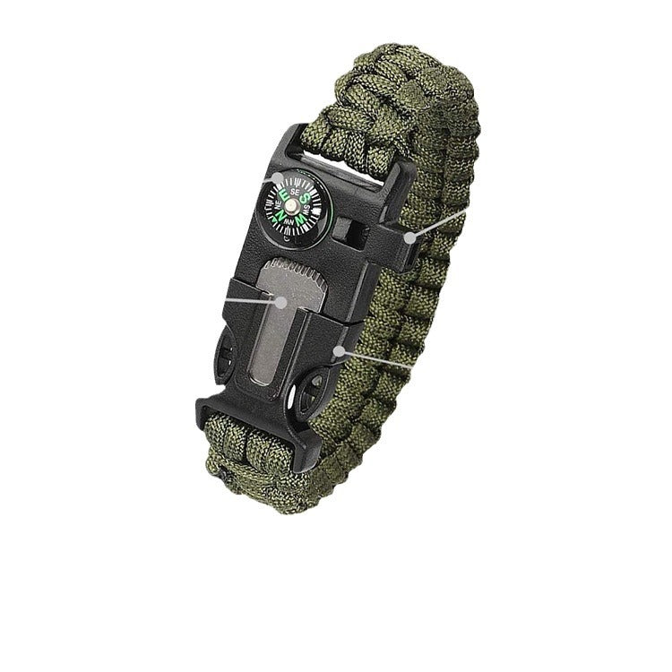 Green paracord bracelet with moulded buckle carrying a compass, a whistle and a striker blade