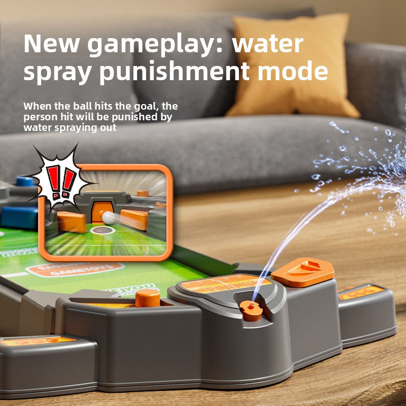 Grey desktop football game showing the water spray punishment mode with a jet of water at the goal