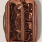 Satin lined interior of the makeup organizer showing padded compartments, mesh pockets and elastic loops