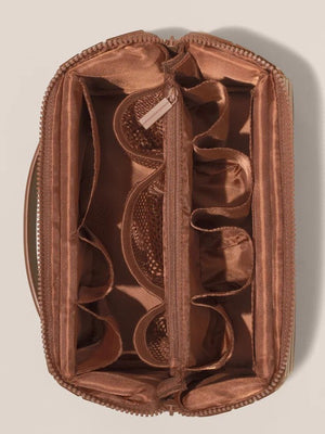 Satin lined interior of the makeup organizer showing padded compartments, mesh pockets and elastic loops