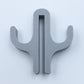 Gray resin double hook with an arm on each side, seen from the front on a light background