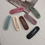 Matte snap hair clips shown together in solid colors