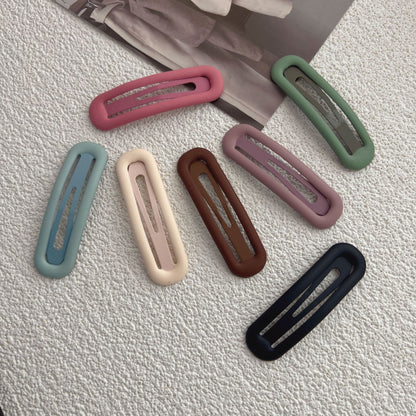 Matte snap hair clips shown together in solid colors