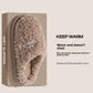 Brown plush slipper in a SOFT SLIPPERS box, KEEP WARM banner