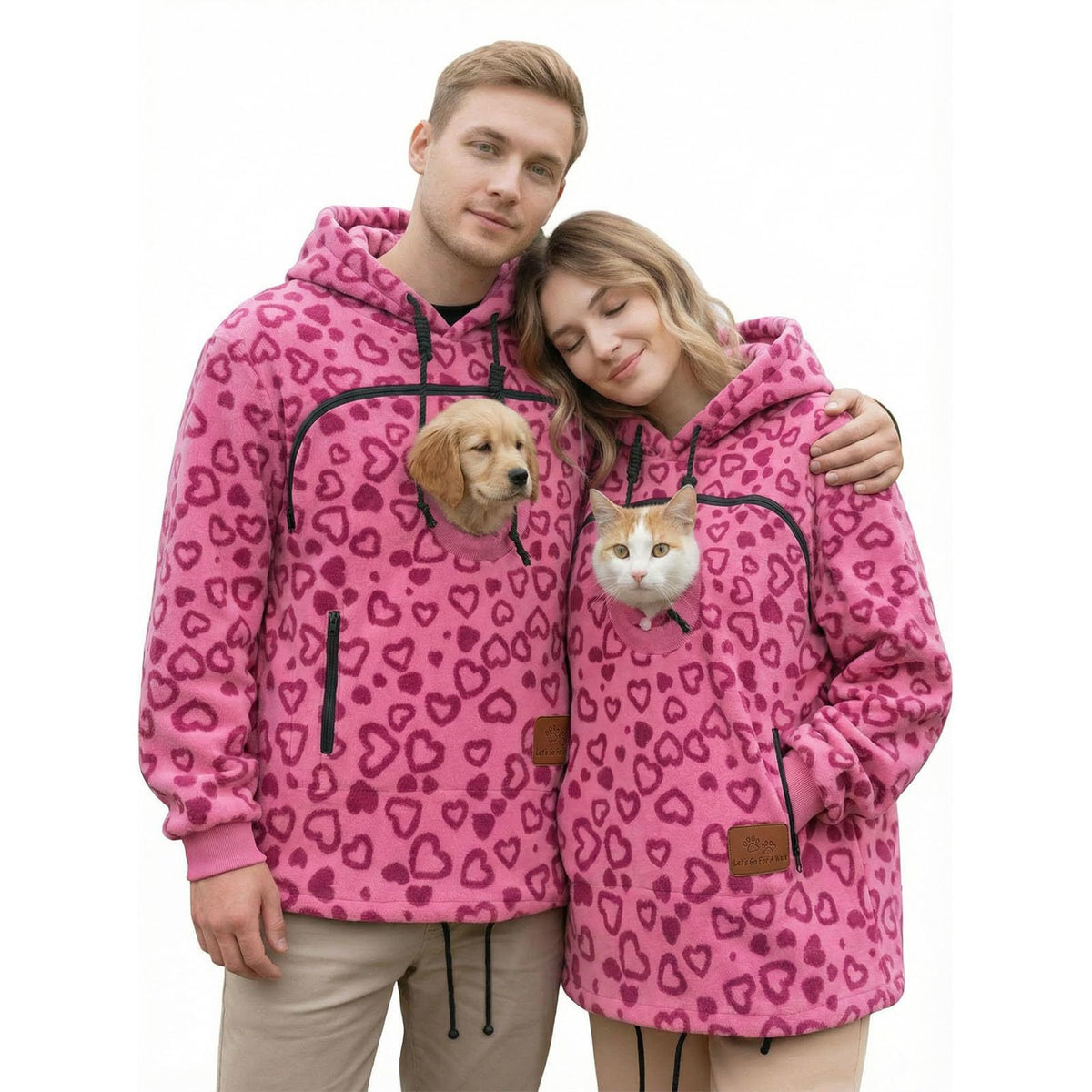 Couple in bright pink heart outline fleece hoodies, a puppy and a cat in the chest pouches, size 3XL option