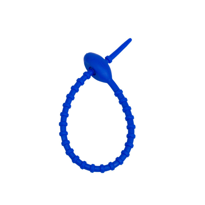Soft silicone tadpole cable tie coiled into a loop to show the reusable cinch closure