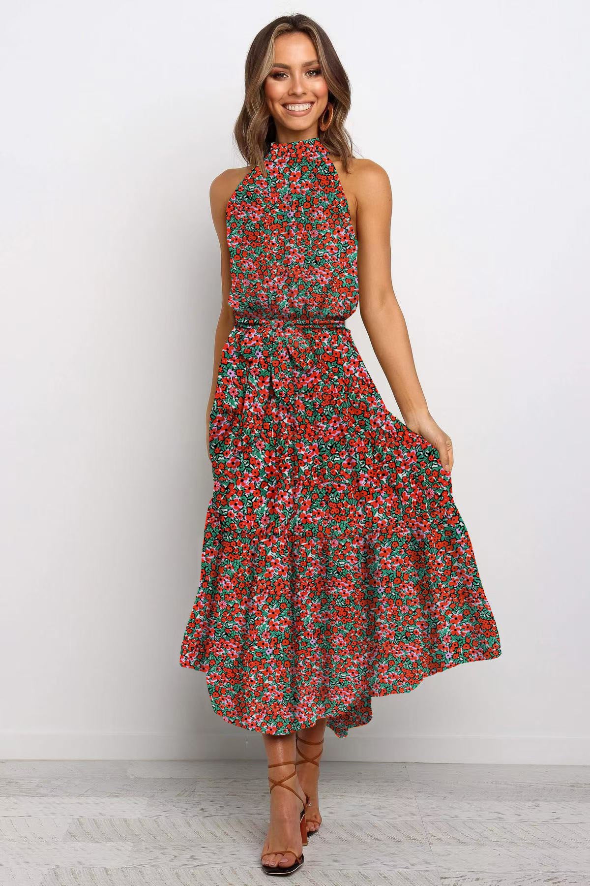 Red and olive boho floral halter neck sleeveless tiered swing maxi dress worn by a model