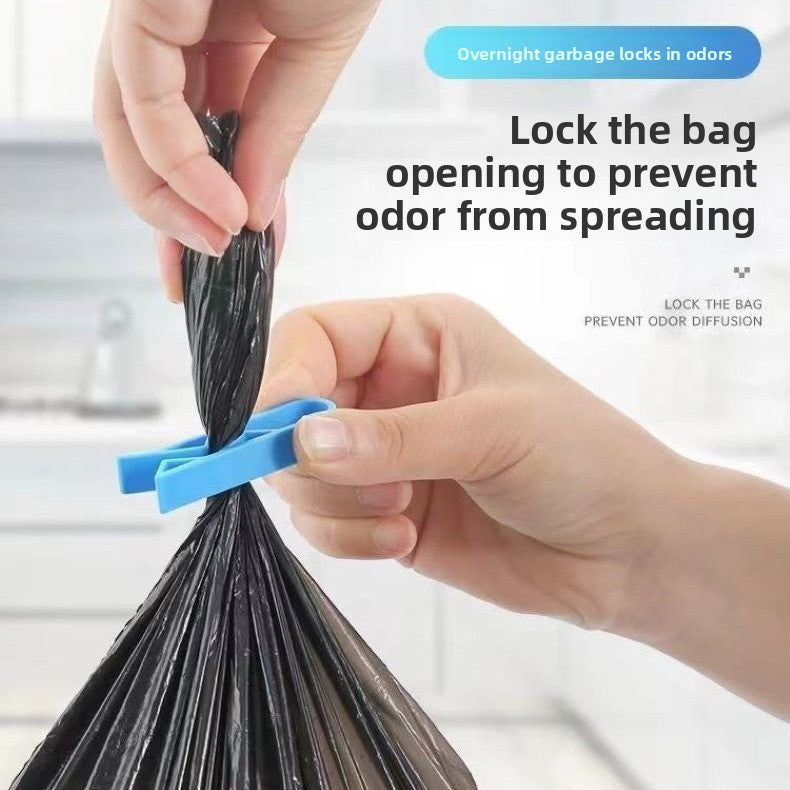 Blue clip pinching a tied garbage bag opening shut to keep smells in