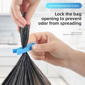 Blue clip pinching a tied garbage bag opening shut to keep smells in