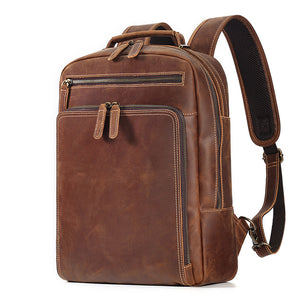 Brown cowhide leather backpack with contrast stitching, front zip pockets and curved shoulder straps