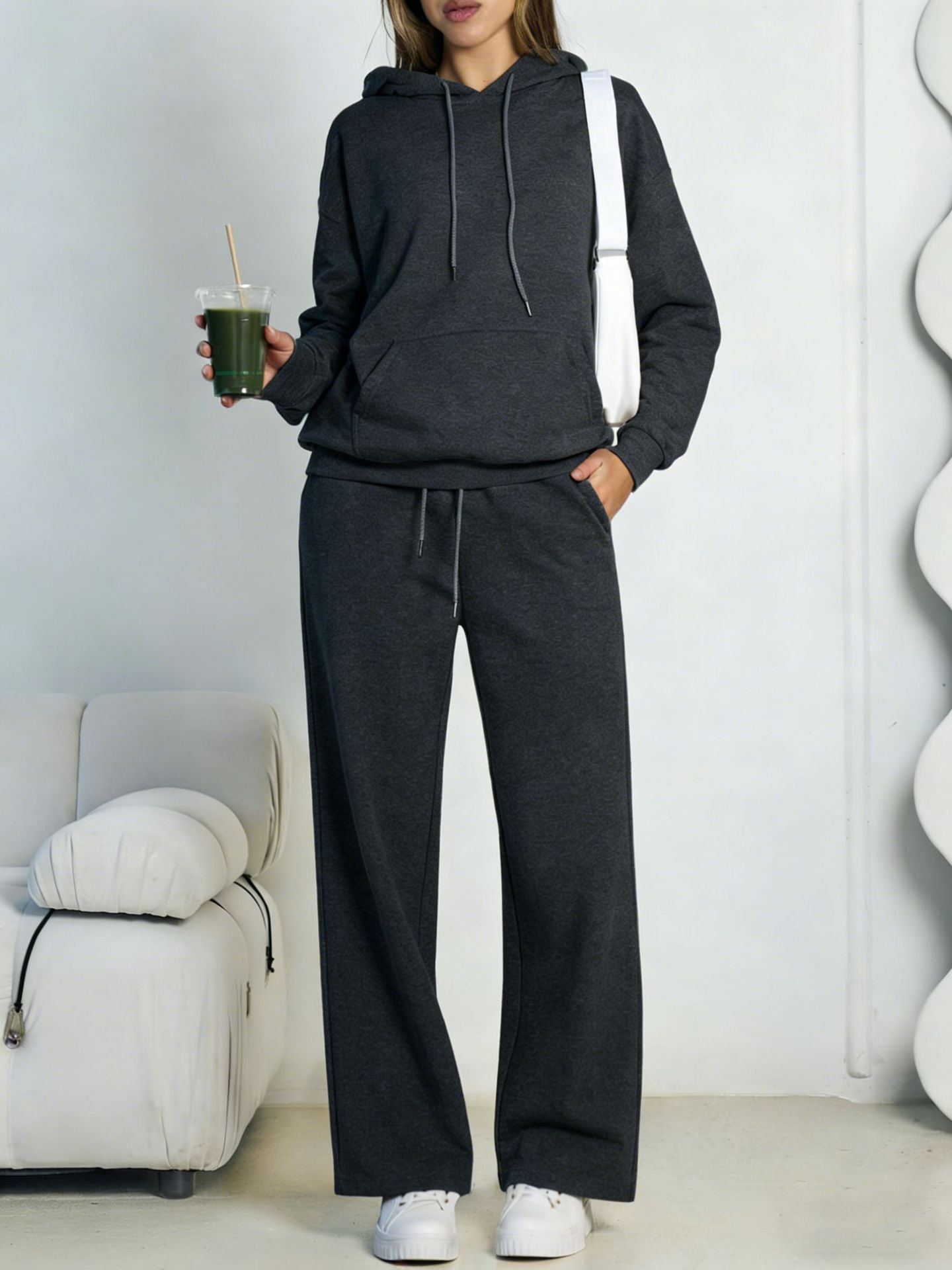 Dark gray fleece hooded sweatshirt and wide-leg sweatpants set worn by a model