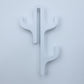 White resin three hook with three arms, seen from the front on a light background