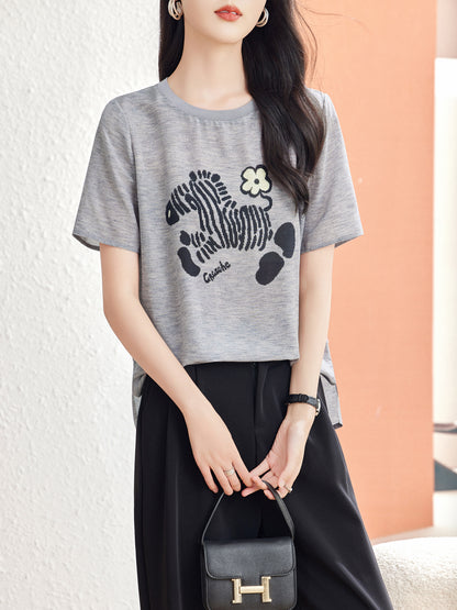 Woman wearing Glacier Gray silk blouse with knit-in zebra motif and cream flower