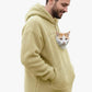 Pale yellow sherpa fleece pet pouch hoodie on a man showing the hand pockets and pouch