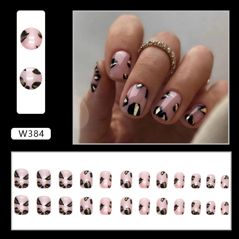 Full cover press-on almond nails in a pink leopard print, glossy finish shown on a hand