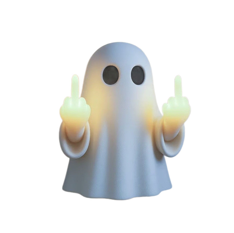 White resin ghost night light on a plain background with its two raised fingers glowing pale